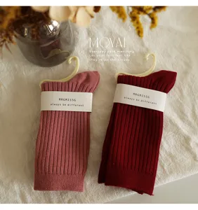 Detailed view of ribbed mid-tube socks in pink and dark red, cozy knit design for daily wear.