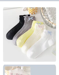 Close-up detail of women's sweet mesh short socks with cute bows in multiple colors.