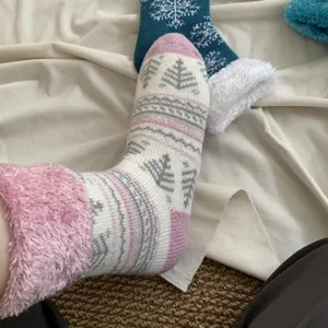 Cozy winter fleece-lined women's socks with cute Fair Isle snowflake patterns for warm feet.