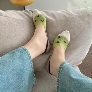 Detail shot of cute floral low cut boat socks worn on sofa, comfortable summer thin invisible style.