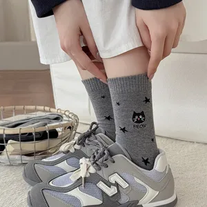 Grey mid-tube women socks featuring cute black cat embroidery, star patterns, and cozy cotton.
