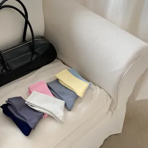 Detailed view of colorful ribbed mid-tube candy socks neatly stacked on white sofa.