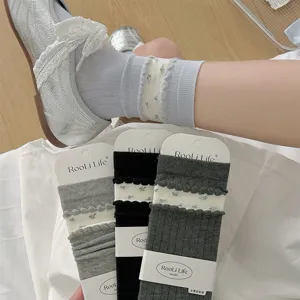 Detail view of women spring summer ruffle floral stack socks with packaging cards showcasing style.