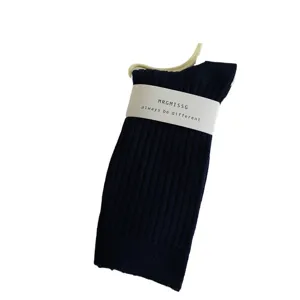 Women's dark blue ribbed mid-tube socks with paper band packaging, comfortable autumn wear.