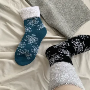 Cozy winter fuzzy socks detail shot showing classic snowflake pattern and warm fleece lining.