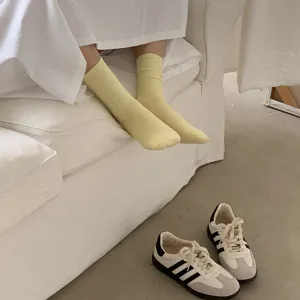 Solid color yellow ribbed mid-tube socks detail, soft cotton knit fabric, cozy spring daily wear.