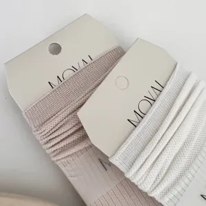 Close-up detail view of breathable mesh crew socks featuring rolled cuffs and soft texture.
