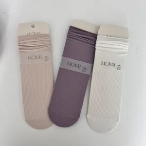 Close-up detail of MOVAI breathable cotton mid-tube socks with rolled cuffs and mesh design.