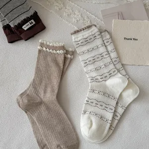 Detailed view of women knit mid-tube socks with cute ruffle edge and geometric patterns.