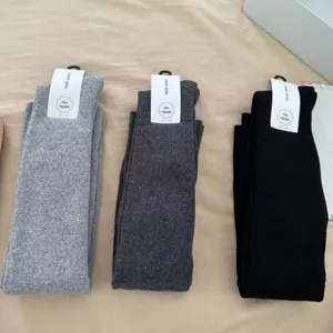Detailed view of thick fleece over-the-knee long socks in three versatile colors, soft knit.