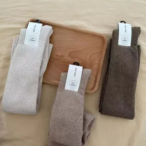 Cozy knit over-knee long socks in neutral autumn colors, soft thick fleece warm winter hosiery.