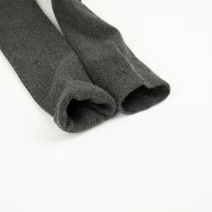 Dark grey ribbed knit long socks detail view, showing soft cotton texture and elastic cuff.