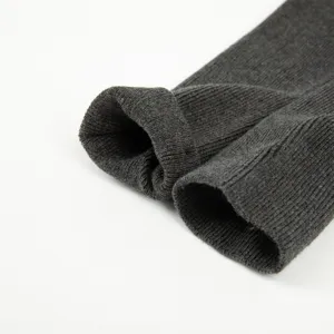 Close-up view of dark grey ribbed knit socks cuff, soft cotton material texture detail.