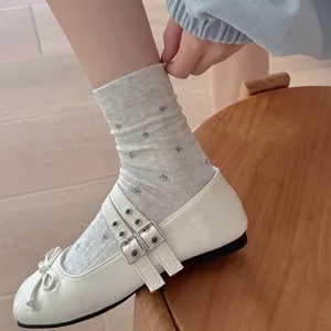 Detail view of autumn retro grey floral mid-tube cotton socks, cute casual daily wear style.
