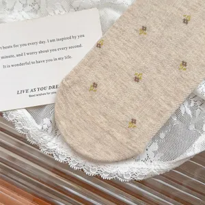 Detail view of autumn floral cotton socks, literary retro style with delicate floral patterns.