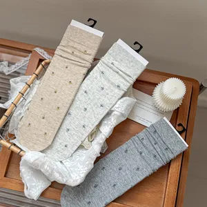 Detailed shot of vintage floral slouch socks placed in a basket, stylish women hosiery.