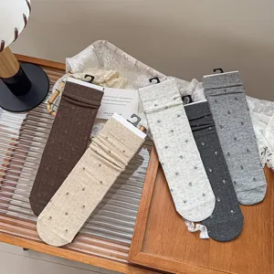 Detailed view of autumn literary style floral stack socks, soft cotton mid-calf women socks.