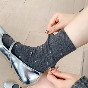 Detailed view of women's dark gray floral crew socks, vintage cotton mid tube socks style.