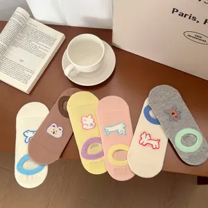 Detailed view of cute cartoon embroidered shallow socks set on aesthetic lifestyle table.