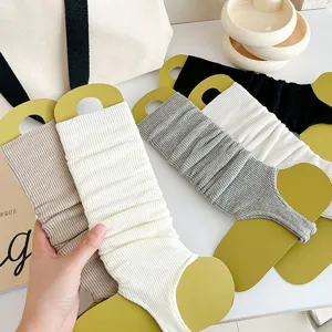 Close-up view of ribbed knit ballet stirrup leg warmers in various colors for daily wear.