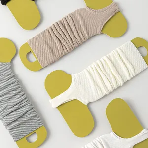 Detail view of spring knit ballet stirrup leg warmers, solid color soft long calf sleeves.