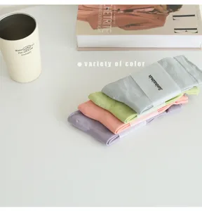 Detail shot of candy color slouch socks stack, soft cotton fabric, elegant Morandi tones.