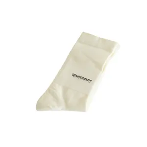 Solid color women mid tube slouch socks with paper band packaging, main product shot white bg