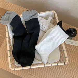 Cozy cotton ribbed crew socks in cream color with contrasting color cuffs for women.