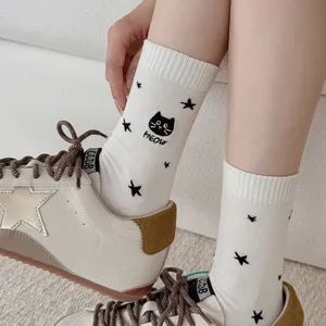 Detail shot of cute cat and star embroidered mid-tube women cotton socks in white style.
