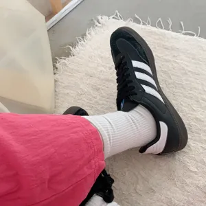 Close-up of white ribbed mid-tube socks, soft cotton fabric texture, comfortable daily wear.