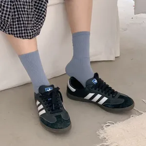 Comfortable grey ribbed mid-tube socks for women and men, classic daily casual wear.