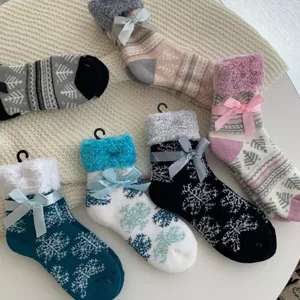 Thickened fleece winter women's warm mid-tube socks with cute bows and snowflake patterns.