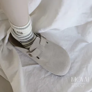Cozy cashmere wool mid-tube socks featuring cute puppy embroidery paired with casual suede clogs.