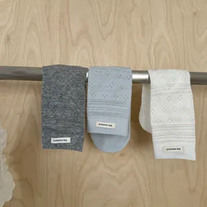 Detail view of solid color hollow stackable socks with cloth label and clover mesh pattern.