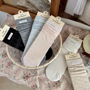 Detailed view of solid hollow stack socks with cloth labels, sweet cute summer mesh socks.