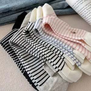 Detailed view of striped contrast mid-tube socks with cute dog embroidery, soft combed cotton.
