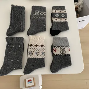 Close-up detail of cozy women winter wool socks with classic fair isle knit patterns.