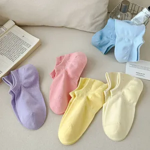 Close-up of colorful dopamine shallow invisible ankle socks flat lay lifestyle detail view.