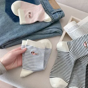 Detailed view of cute striped mid-tube socks featuring adorable dog embroidery, soft cotton.