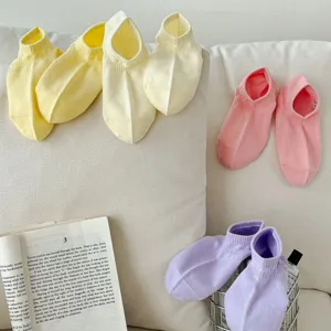 Close-up of colorful shallow-cut dopamine socks in pastel yellow, pink, and purple for spring.