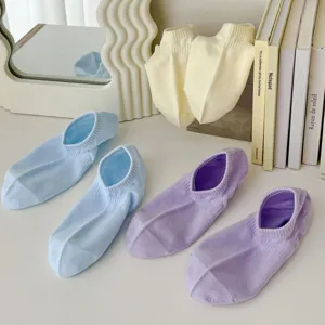 Close-up detail of soft pastel low-cut socks in soothing dopamine colors, neatly arranged.
