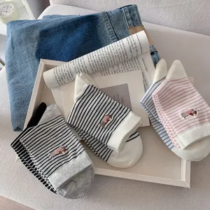 Detailed view of women striped cotton mid-tube socks featuring cute puppy embroidery design.