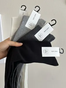 Comfortable soft over-the-knee solid color long socks set in black, grey, and white with tags.