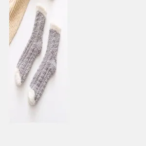 Cozy thick fuzzy winter socks detail shot, grey cable knit texture with plush white trim.