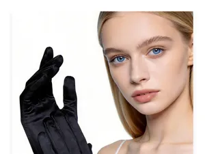 Detailed close-up view of elegant black satin evening gloves worn by model, smooth texture.