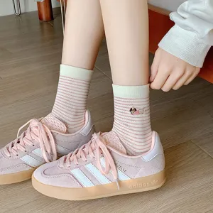 Detail view of striped cotton mid-calf socks with cute puppy embroidery and pink hues.