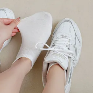 White cotton short socks detail shot, soft breathable fabric, comfortable ankle fit for daily wear.