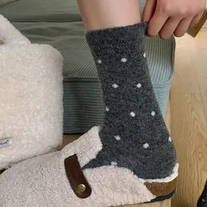 Women winter warm thick wool mid-calf socks with cute star patterns, cozy daily wear style.