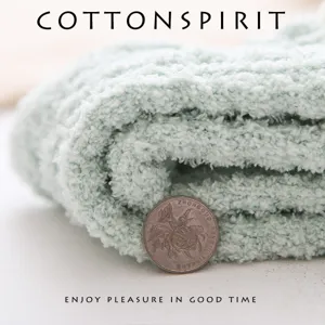 Thickened coral fleece warm winter mid-tube socks in soft light green color, close-up view.