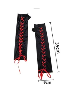 Close-up detail of black satin long fingerless gloves featuring vibrant red lace-up ribbon design.